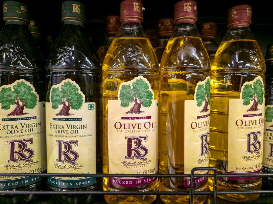 Bottles of olive oil arranged on a shelf